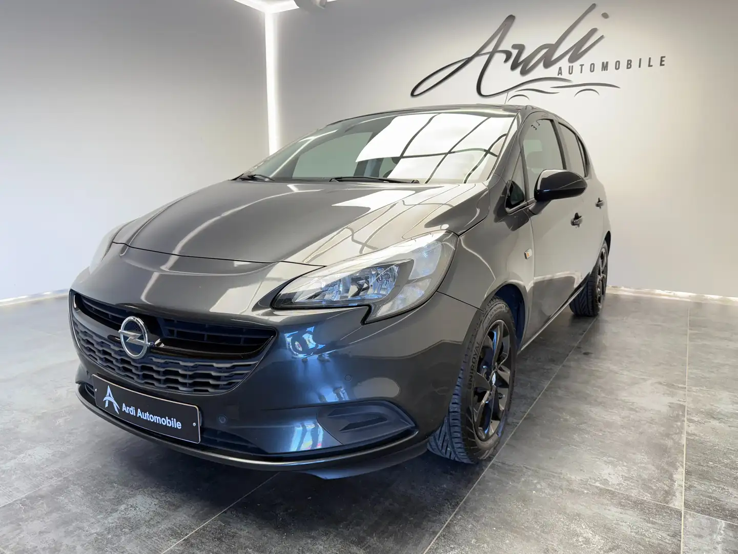 Opel Corsa 1.4 Turbo*CARPLAY*PARK ASSIST*1ER PROP*GARAGE* Grijs - 1