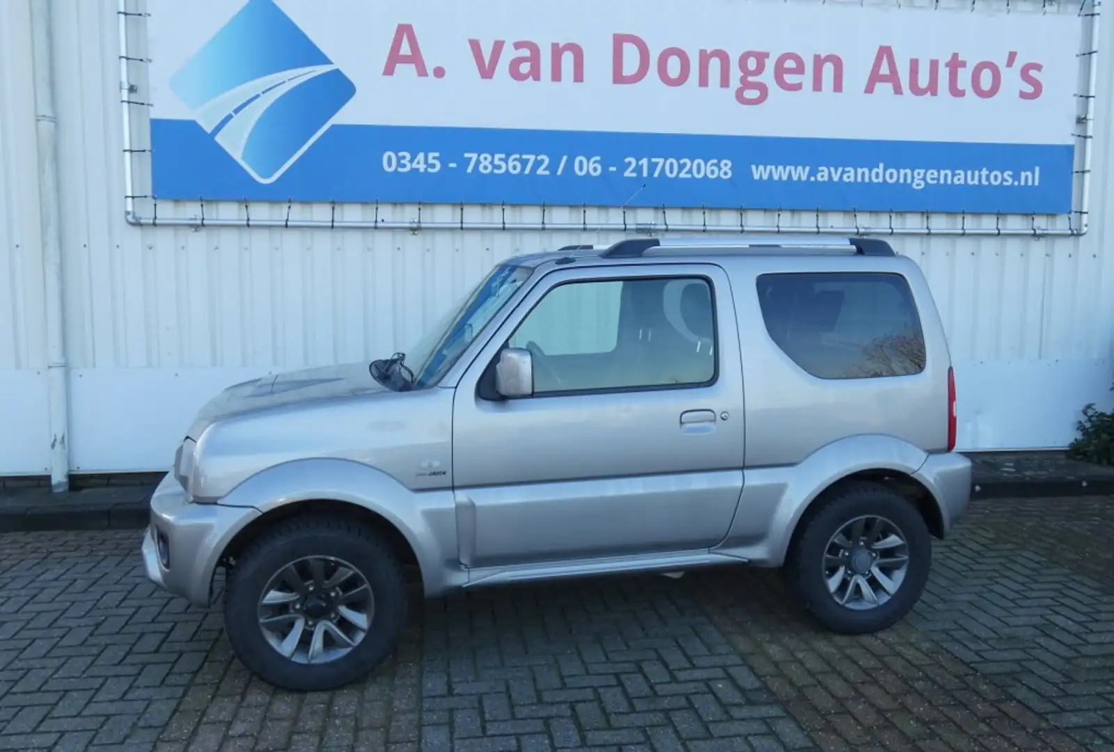 Suzuki Jimny 1.3 EXCLUSIVE 4WD,Leer,Stoelverw,1e Eignr,Trhaak Gris - 1
