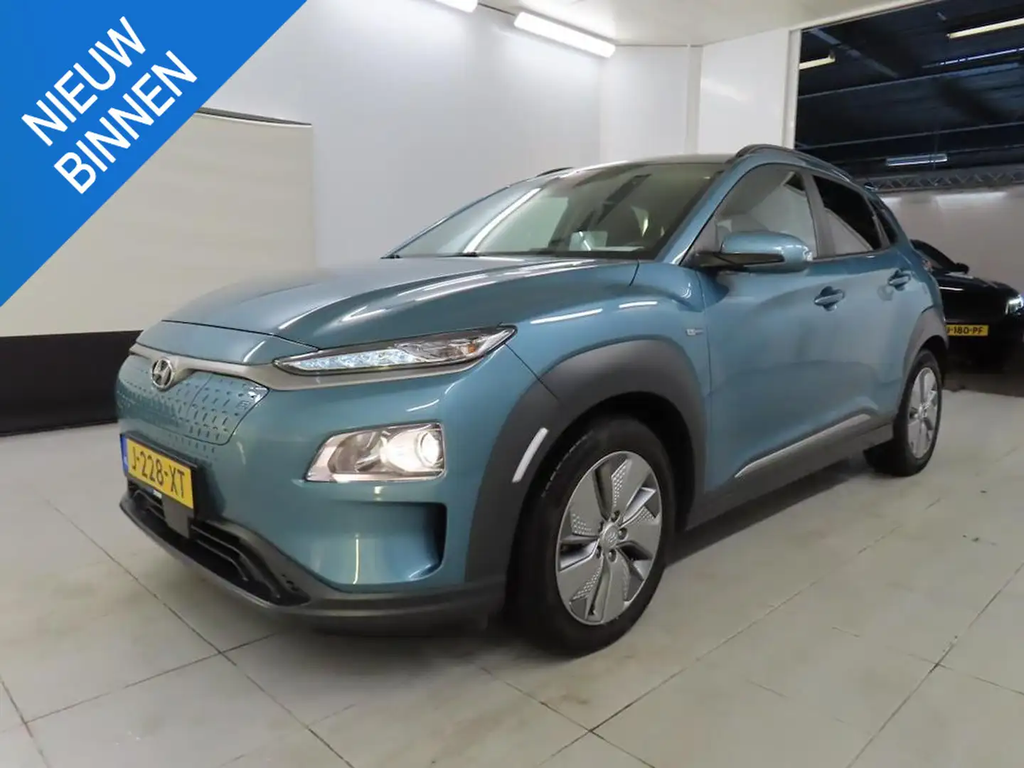 Hyundai KONA EV FASHION 64 KWH I 3 FASE I 100% SOH I P-CAMERA I Blauw - 1