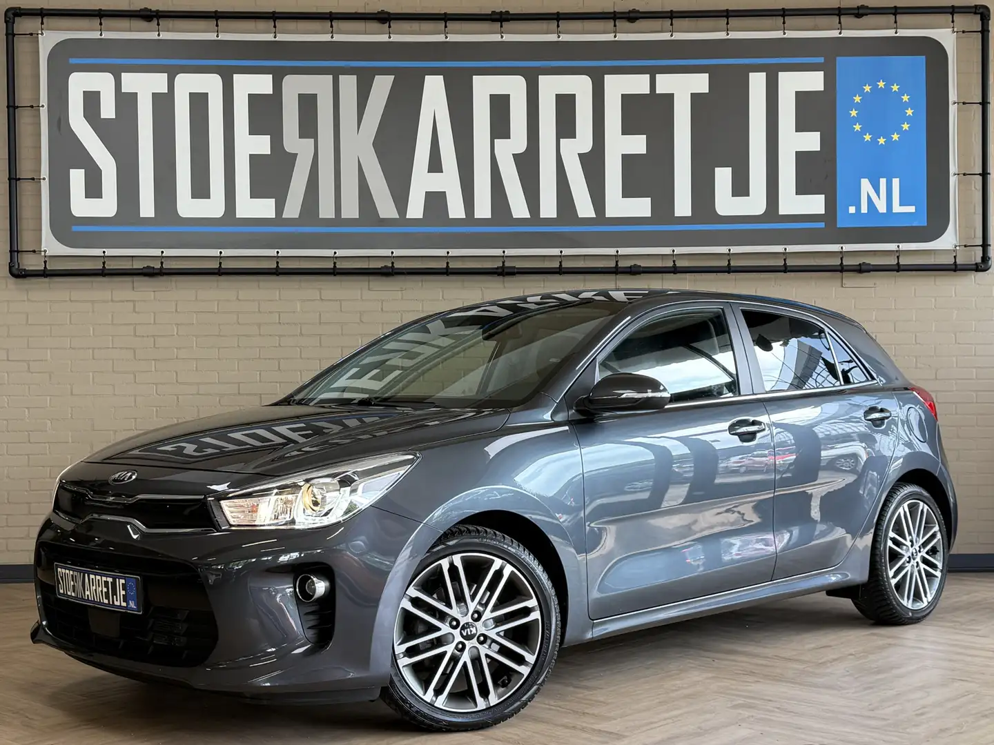 Kia Rio 1.4 100pk Executive Line | Navigatie | Leder | Cam Grey - 1