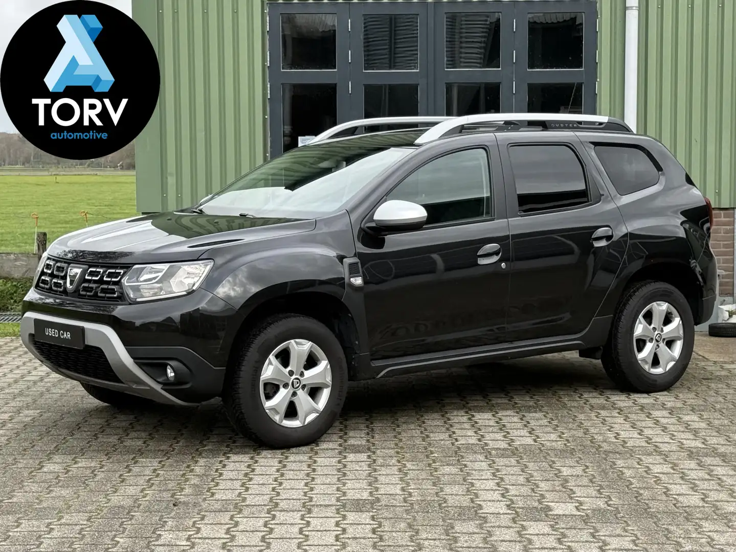 Dacia Duster 1.2 TCe Comfort | 1e Eigenaar | Trekhaak | Navigat Zwart - 1