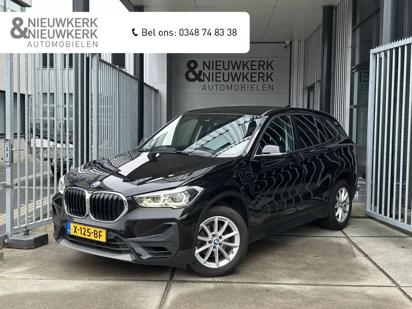 BMW X1 sDrive18i | AUTOMAAT | NAVI | CRUISE CONTROL | PDC Zwart - 1