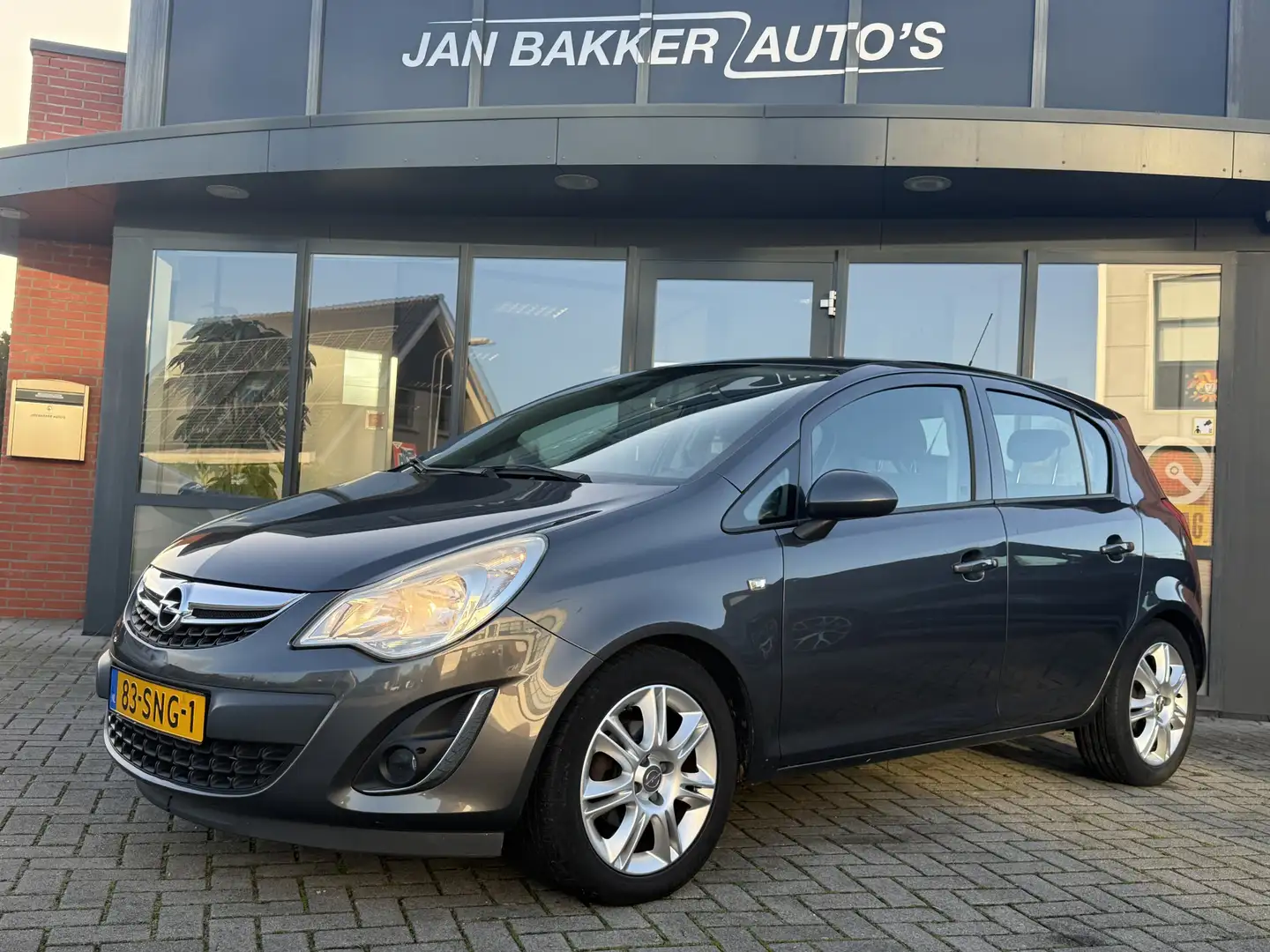 Opel Corsa 1.2-16V Edition ✅ AC ✅ Cruise ✅ LMV ✅ 5 Deurs ✅ Grijs - 1