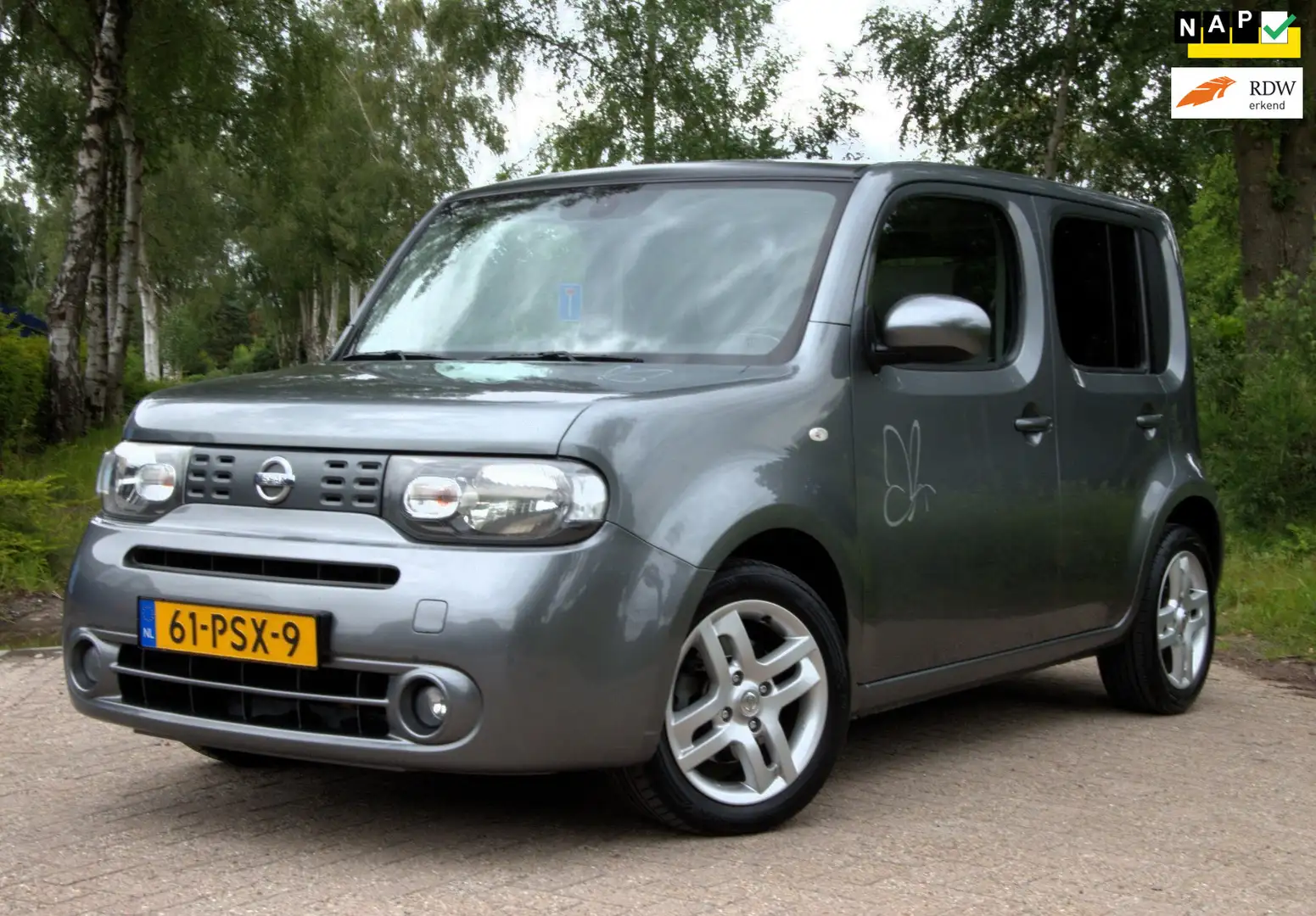 Nissan Cube 1.6 Zen, Automaat, NAP, Cruise, Camera, Clima Grau - 1