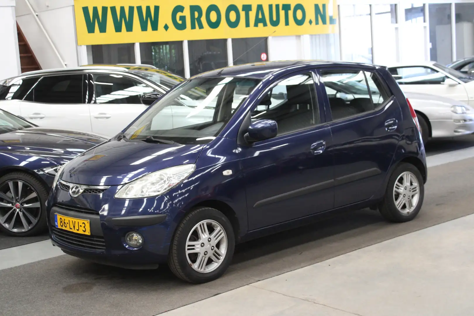 Hyundai i10 1.25i i-Catcher Automaat 90.271km NAP, Airco, Stuu Blauw - 1