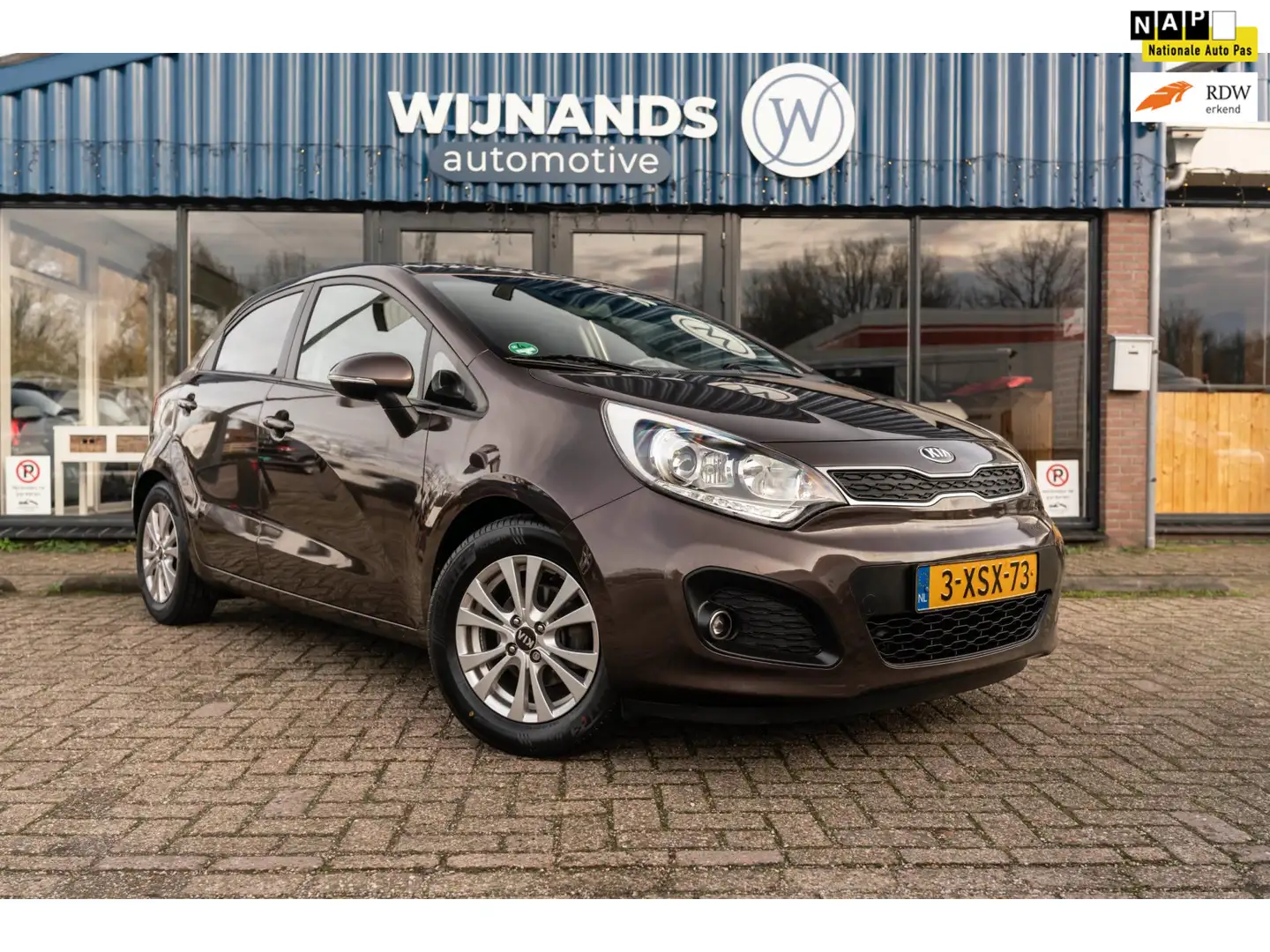 Kia Rio 1.2 CVVT Super Pack Keyless Cruise Clima Parks Lic Bruin - 1